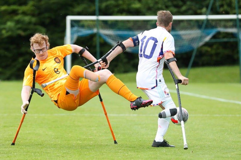 A player strikes acrobatically in front of goal as the keeper looks on