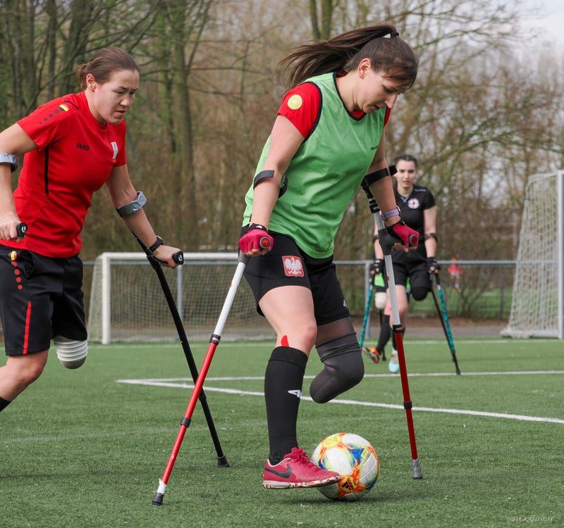 Two women players challenge for the ball during a drill