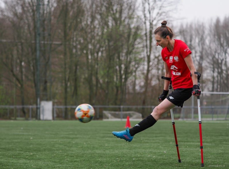 A woman player strikes the ball at the women’s camp